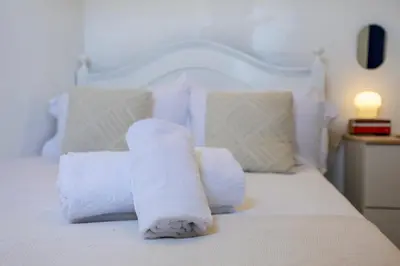 a pile of towels sitting on top of a bed at Casa Ana Mar in Vila do Bispo