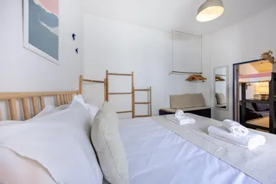 a white bed with two towels on top of it at Casa Ana Mar in Vila do Bispo