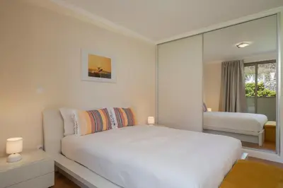 a white bedroom with a large bed and a window at Calheta Victory View by An Island Apart in Calheta