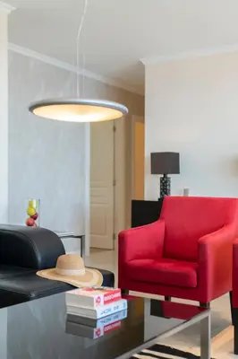 a living room with a red couch and a red chair at Calheta Victory View by An Island Apart in Calheta