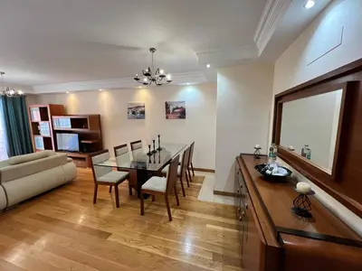 a dining room and living room with a table and chairs at Agustin's House in Funchal