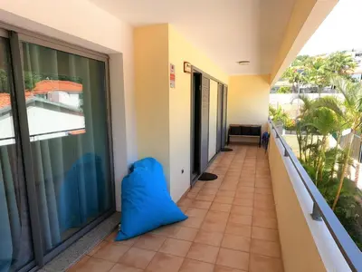 a balcony with a blue pillow on the floor at Agustin's House in Funchal