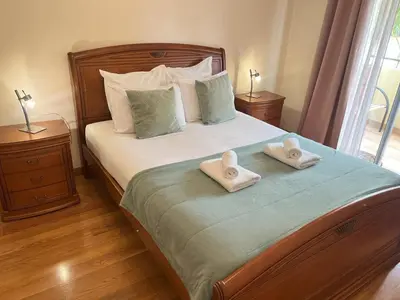 a bedroom with a bed with two towels on it at Agustin's House in Funchal
