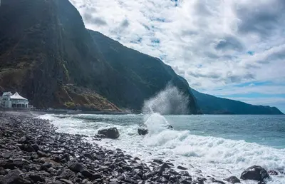a rocky beach with waves crashing on the shore at Amarelo Apartment by Atlantic Holiday in São Vicente