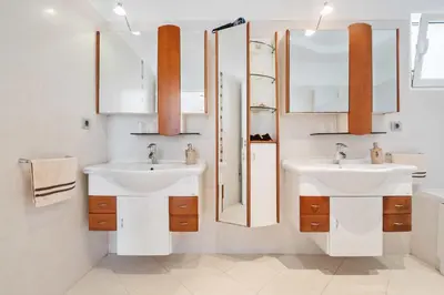 a bathroom with two sinks and two mirrors at Villa Funchal bay view in Funchal