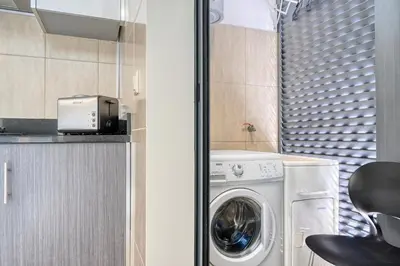 a laundry room with a washer and dryer in it at Baia Machico, a Home in Madeira in Machico