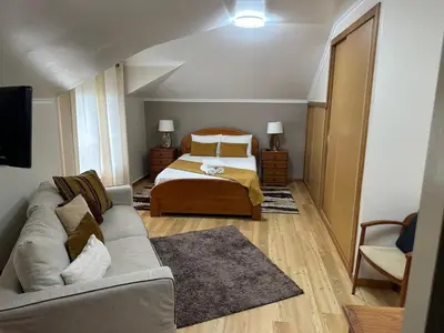 a living room with a bed and a couch at Moniz Apartment in Caniço