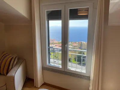 a room with a window with a view of the ocean at Moniz Apartment in Caniço