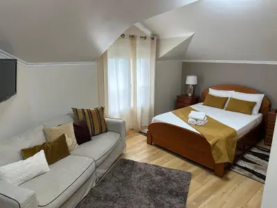 a small bedroom with a bed and a couch at Moniz Apartment in Caniço