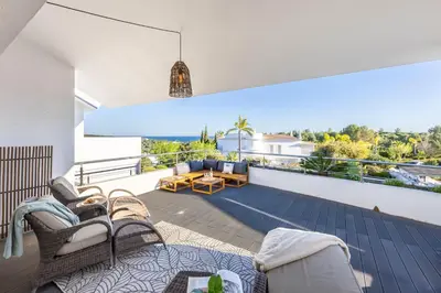 a living room with a fireplace and a table and chairs at Burgau Sea View, Beach & Pool Villa in Budens