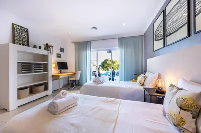 a balcony with a bed and a view of the ocean at Burgau Sea View, Beach & Pool Villa in Budens