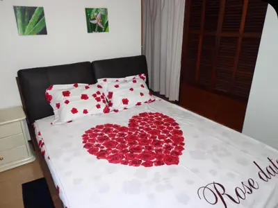 a bed with a heart made out of red roses at Apartamentos do Mar Funchal in Funchal