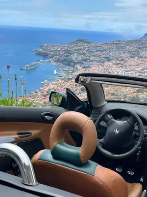 a car with a steering wheel and a view of the ocean at Penthouse Canico Mar in Caniço