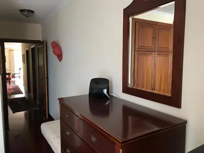 a bedroom with a dresser and a mirror on the wall at Penthouse Canico Mar in Caniço