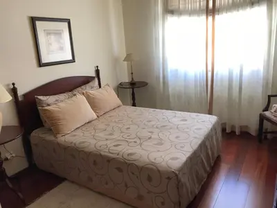 a bedroom with a bed and a large window at Penthouse Canico Mar in Caniço
