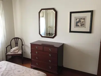 a bedroom with a dresser and a mirror on a wall at Penthouse Canico Mar in Caniço