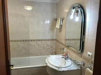 a bathroom with a sink and a bath tub at Penthouse Canico Mar in Caniço