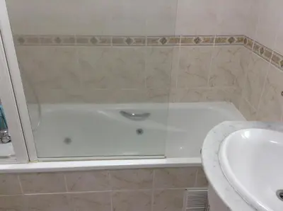 a bathroom with a bath tub and a sink at Penthouse Canico Mar in Caniço