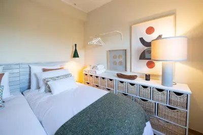 a bedroom with a bed and a table with a lamp at Moonrise Flat in Aljezur