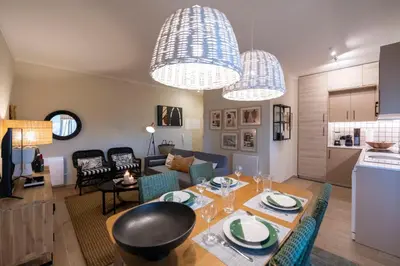 a kitchen and living room with a table and chairs at Moonrise Flat in Aljezur