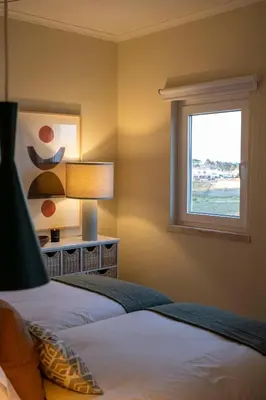 a bedroom with a bed and a window at Moonrise Flat in Aljezur