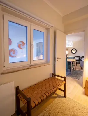 a bench sitting in a room with a window at Moonrise Flat in Aljezur