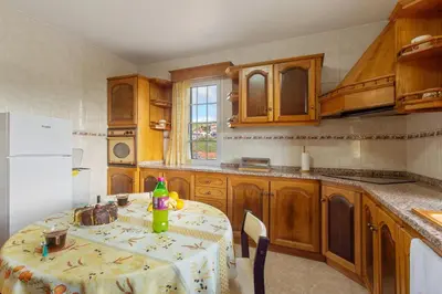 a kitchen with a table with a bottle on it at Apartamento Maria in Canhas