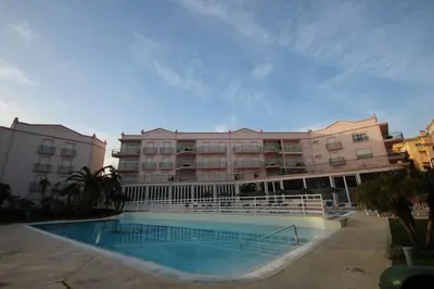 a hotel with a swimming pool in front of a building at JM - St James, apart com WIFI, piscina a 50 mt da Praia in Lagos