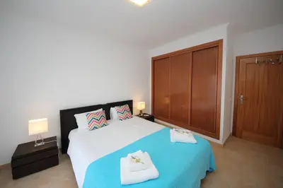 a bedroom with a large bed with two towels on it at JM - St James, apart com WIFI, piscina a 50 mt da Praia in Lagos