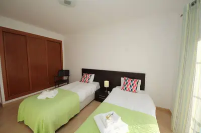 a bedroom with two beds with green sheets at JM - St James, apart com WIFI, piscina a 50 mt da Praia in Lagos