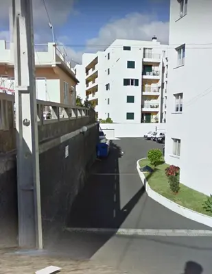 a view of a street between two buildings at Por do Sol in Caniço