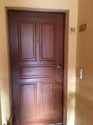 a large wooden door in a room with a doorestamp at Por do Sol in Caniço