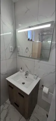 a bathroom with a sink and a mirror at Por do Sol in Caniço