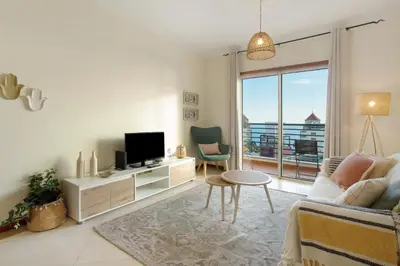 a living room with a couch and a tv at Sea View Apartment in Funchal