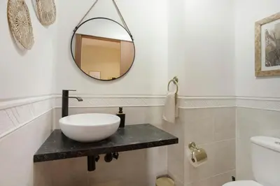 a bathroom with a sink and a mirror on a counter at Sea View Apartment in Funchal