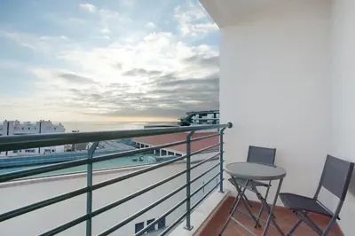 a balcony with two chairs and a view of the ocean at Sea View Apartment in Funchal