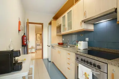 a kitchen with a sink and a stove at Sea View Apartment in Funchal