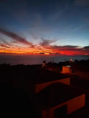 a sunset over a body of water with the sky at Casa Vida Alegre in Prazeres