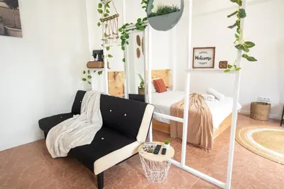 a living room with a chair and a bed at The Village House in Machico