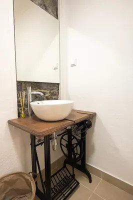 a bathroom with a sink and a mirror at The Village House in Machico