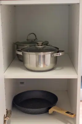 two pots and pans sitting on top of a shelf at The Village House in Machico