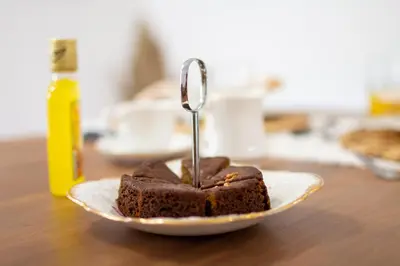a piece of chocolate cake on a plate with a spoon at The Village House in Machico