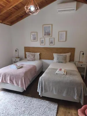 two beds sitting next to each other in a bedroom at CASA GIRASSOL 