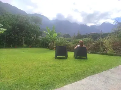 a woman sitting in a chair in the grass at CASA GIRASSOL 