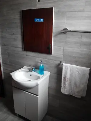 a kitchen with a white refrigerator and a microwave at Vivenda Familia Pedro in Vila do Bispo