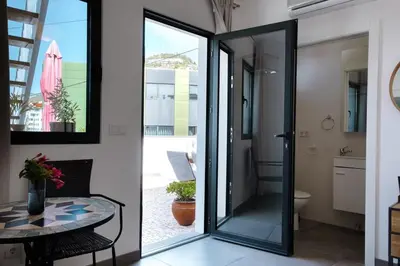 a glass door leading into a bathroom with a table at GuestReady - Anakaj House in Funchal