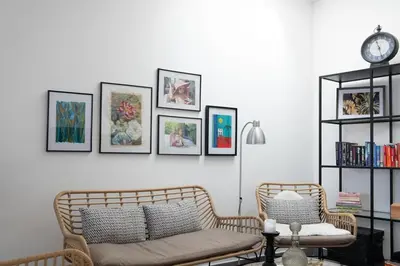 a living room with a couch and pictures on the wall at GuestReady - Anakaj House in Funchal