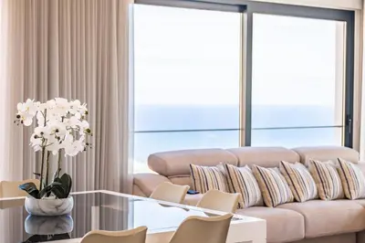 a living room with a couch and a table and chairs at Belle Maison by Homie in Funchal