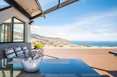 a patio with a view of the ocean from a house at Belle Maison by Homie in Funchal