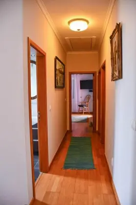 a hallway of a home with a green rug at Bluehouse Paraiso á beira Mar in São Vicente